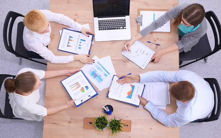 Business people sitting and discussing at business meeting, in office